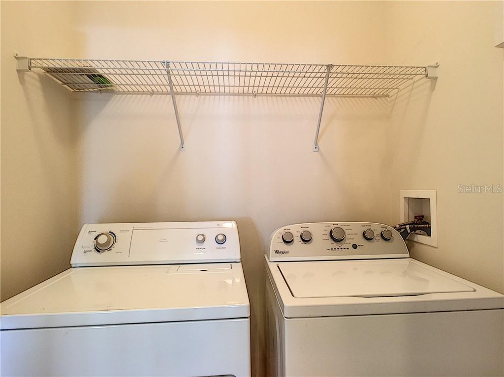 12824 Madison Pointe Circle, Unit 103 Orlando, FL 32821 - Photo 12 of 27 a utility room with dryer and washer