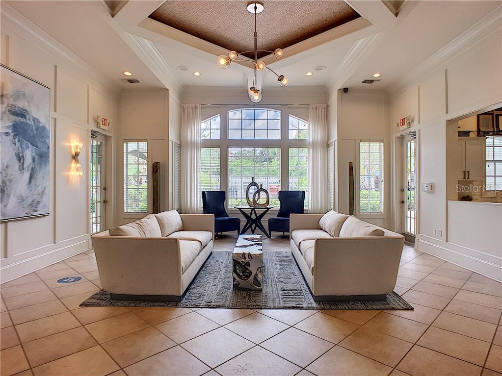 12824 Madison Pointe Circle, Unit 103 Orlando, FL 32821 - Photo 14 of 27 a living room with furniture and a large window
