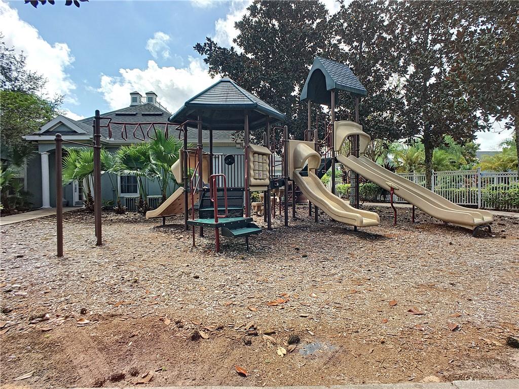 12824 Madison Pointe Circle, Unit 103 Orlando, FL 32821 - Photo 22 of 27 a view of a park with a slide