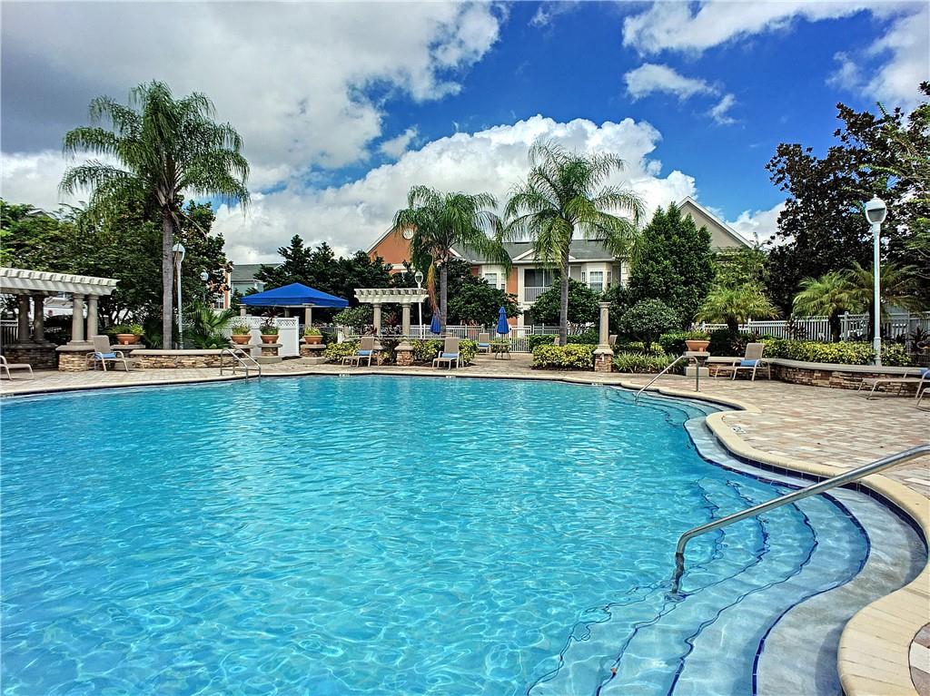 12824 Madison Pointe Circle, Unit 103 Orlando, FL 32821 - Photo 24 of 27 a view of swimming pool with outdoor seating