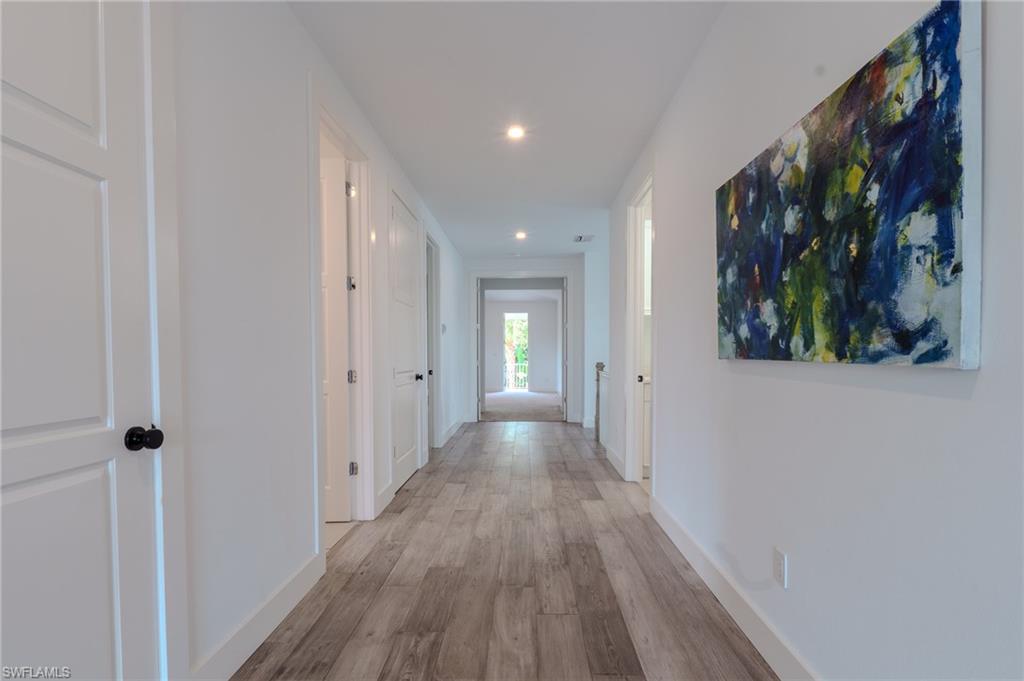 1075 Frank Whiteman Boulevard Naples, FL 34103 - Photo 24 of 43 Wonderfully wide hallways bring it altogether- that closed door is the LAUNDRY ROOM w/sink