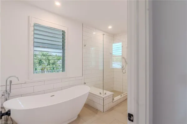 a bathroom with a bathtub and shower