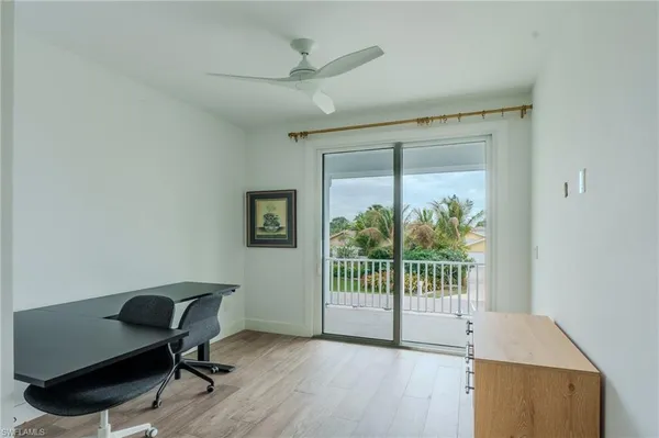 a view of a workspace with furniture and a window
