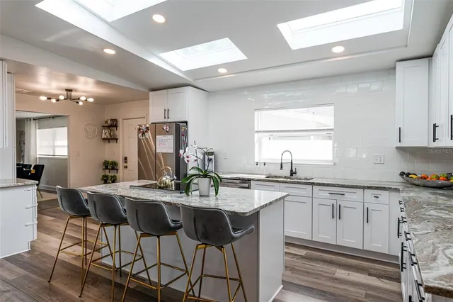 a kitchen with center island table and chairs in it