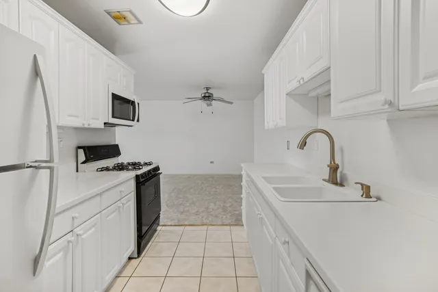 a kitchen with a sink stove and refrigerator