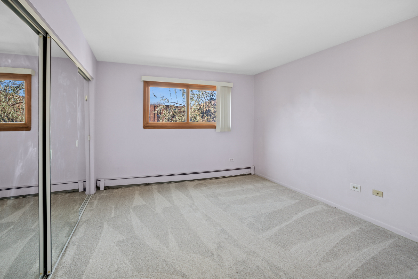 8905 Knight Avenue, Unit 211 Des Plaines, IL 60016 - Photo 19 of 24 an empty room with a painting on the wall