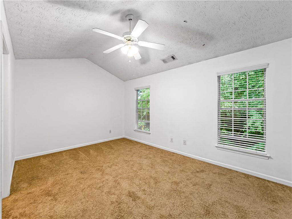 2523 Walden Lake Drive Decatur, GA 30035 - Photo 14 of 18 an empty room with windows and fan