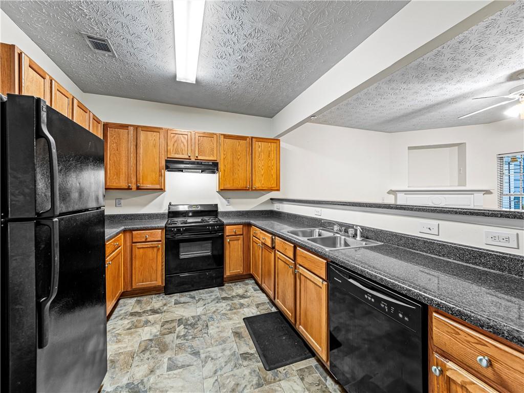 2523 Walden Lake Drive Decatur, GA 30035 - Photo 5 of 18 a kitchen with stainless steel appliances granite countertop a stove sink and refrigerator