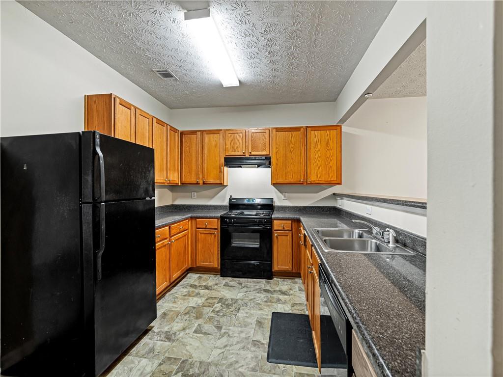 2523 Walden Lake Drive Decatur, GA 30035 - Photo 6 of 18 a kitchen with granite countertop stainless steel appliances a refrigerator stove top oven and sink