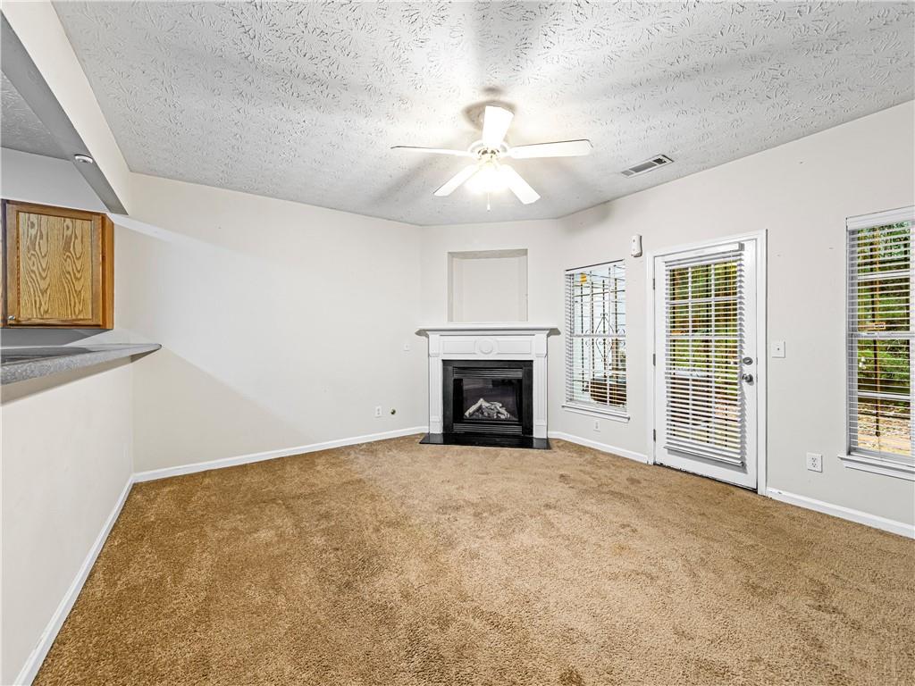 2523 Walden Lake Drive Decatur, GA 30035 - Photo 7 of 18 a view of an empty room with a fireplace and a window