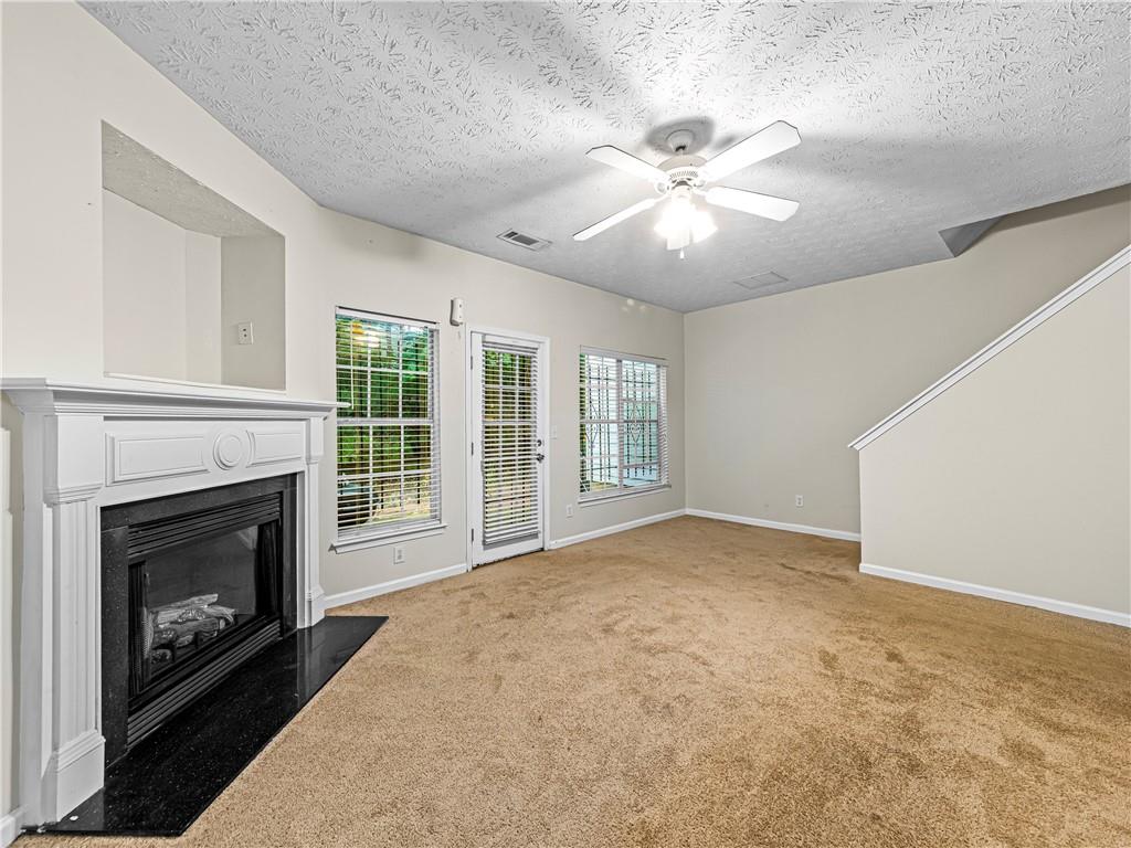 2523 Walden Lake Drive Decatur, GA 30035 - Photo 8 of 18 a view of livingroom with fireplace fan and windows