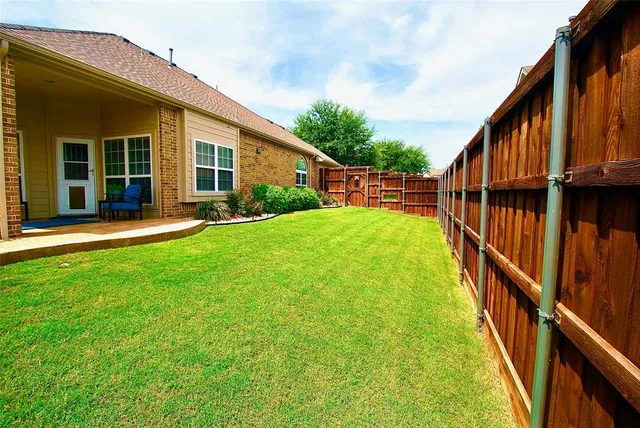a view of an house with backyard and porch