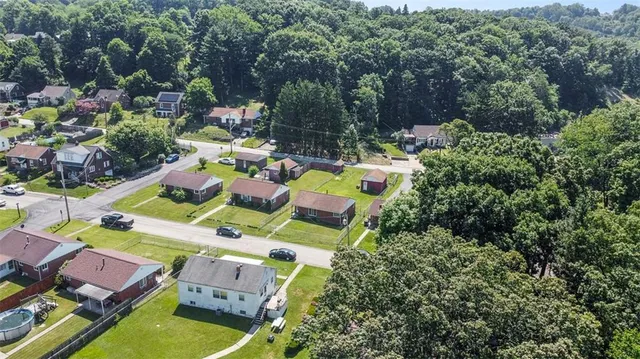 an aerial view of residential houses with outdoor space