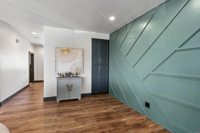 a bedroom with a bed a dresser and a window