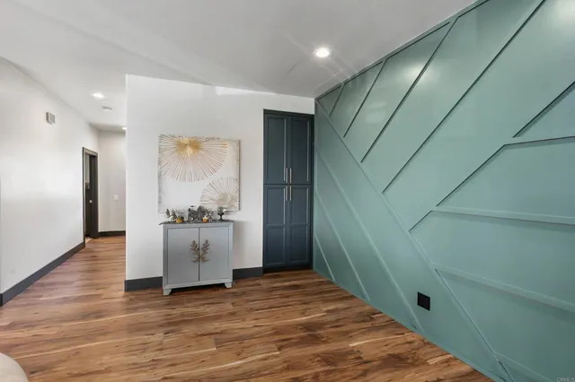 a bedroom with a bed a dresser and a window