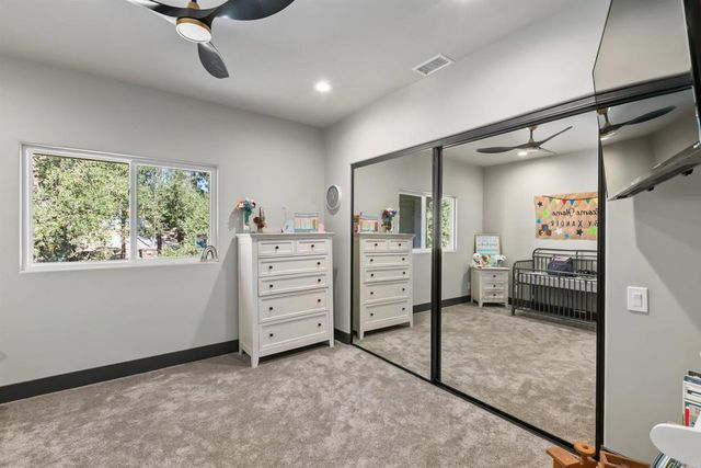 a living room with furniture a flat screen tv and a window