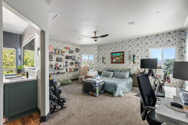 a view of a workspace with furniture and a flat screen tv
