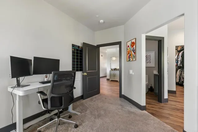 a view of a living room with furniture and wooden floor
