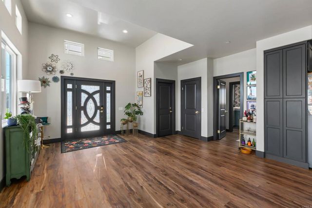a view of an entryway with wooden floor