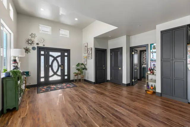 a view of an entryway with wooden floor