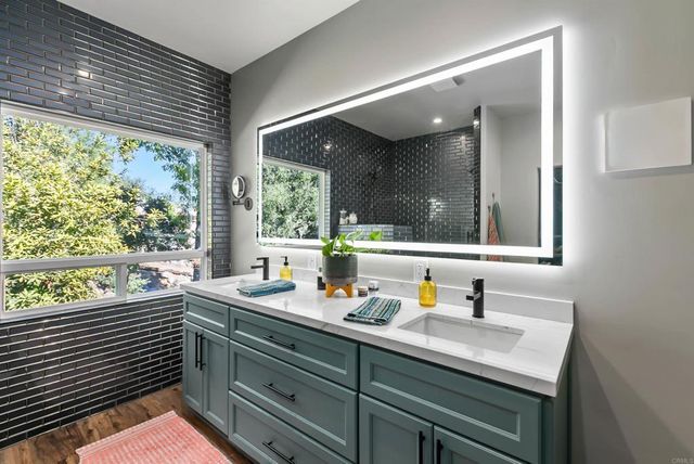 a view of a livingroom with wooden floor and white walls