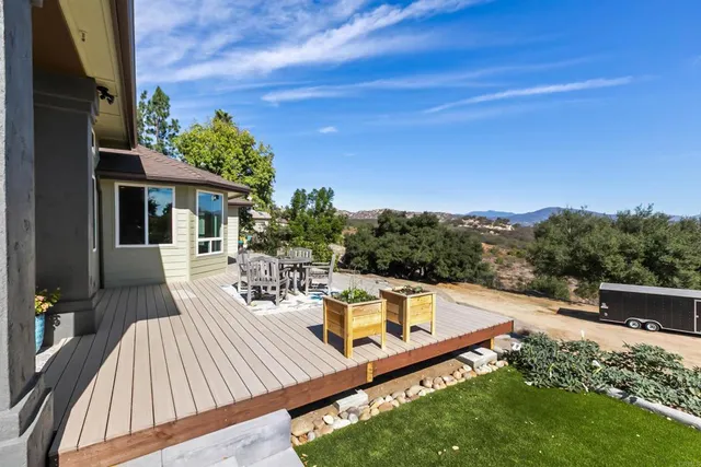 a view of a patio with table and chairs and potted plants