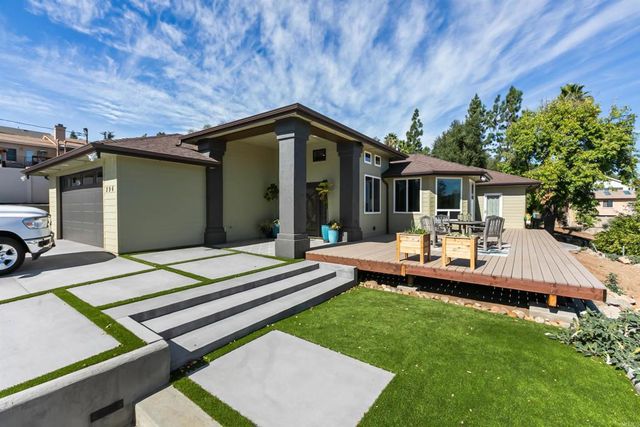 a view of a patio with table and chairs under an umbrella