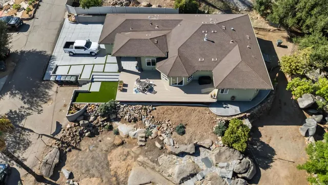 a view of a house with a yard and sitting area