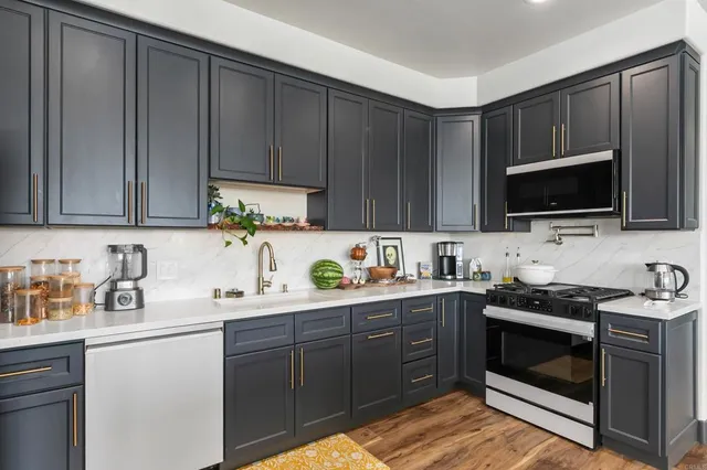 a kitchen with a table chairs and wooden floor