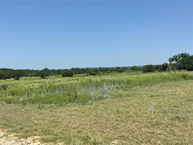 a view of a lake with a yard