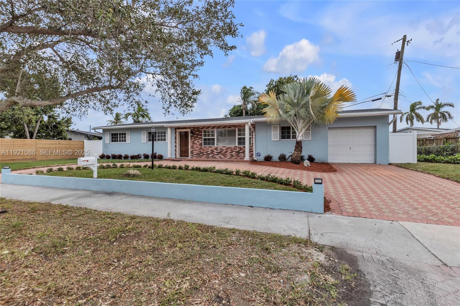 a front view of a house with a garden and swimming pool