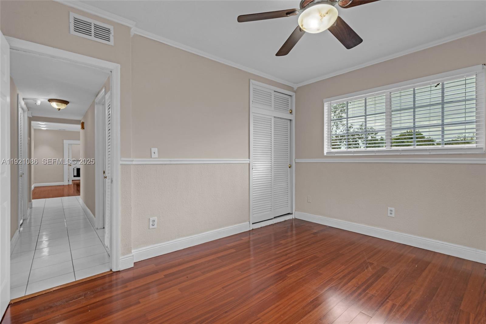 9400 Southwest 193rd Drive, Unit 9400 Cutler Bay, FL 33157 - Photo 12 of 42 a view of empty room with wooden floor and fan