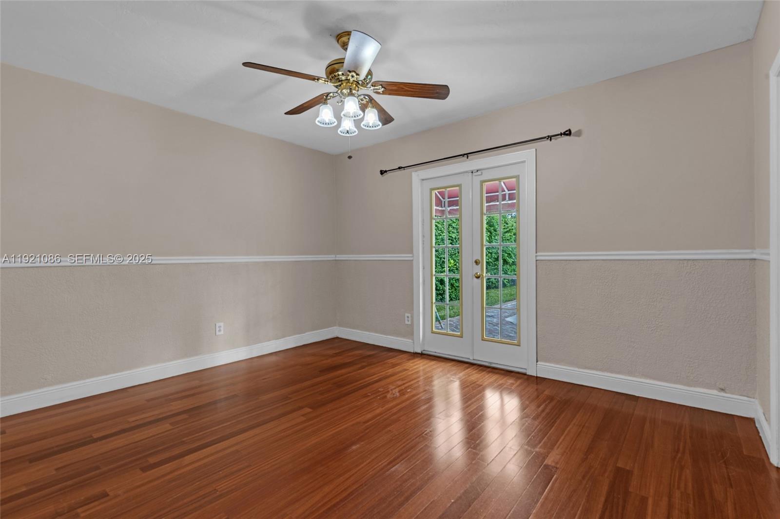 9400 Southwest 193rd Drive, Unit 9400 Cutler Bay, FL 33157 - Photo 13 of 42 a view of an empty room with wooden floor and a window