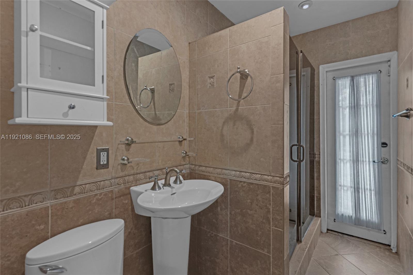 9400 Southwest 193rd Drive, Unit 9400 Cutler Bay, FL 33157 - Photo 19 of 42 a bathroom with a sink toilet and shower