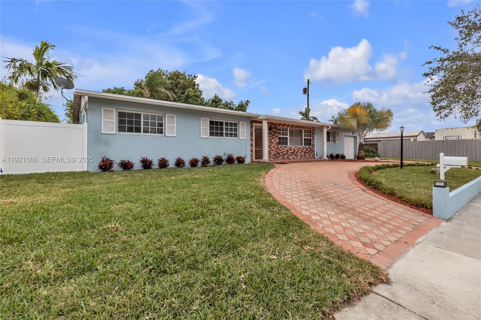 9400 Southwest 193rd Drive, Unit 9400 Cutler Bay, FL 33157 - Photo 2 of 42 a front view of a house with a garden and plants