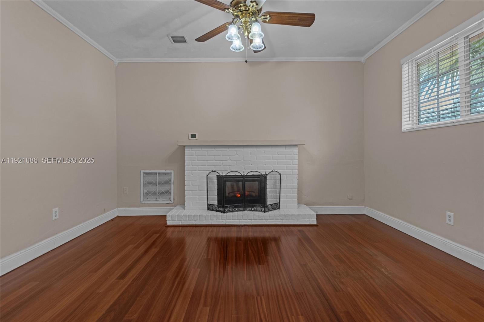 9400 Southwest 193rd Drive, Unit 9400 Cutler Bay, FL 33157 - Photo 23 of 42 wooden floor fireplace and window in an empty room