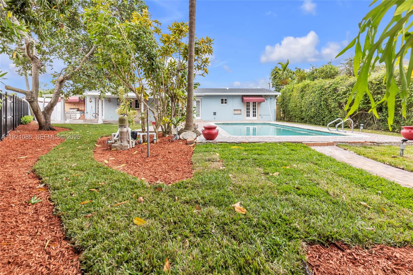 9400 Southwest 193rd Drive, Unit 9400 Cutler Bay, FL 33157 - Photo 34 of 42 a front view of house with yard and trees in the background