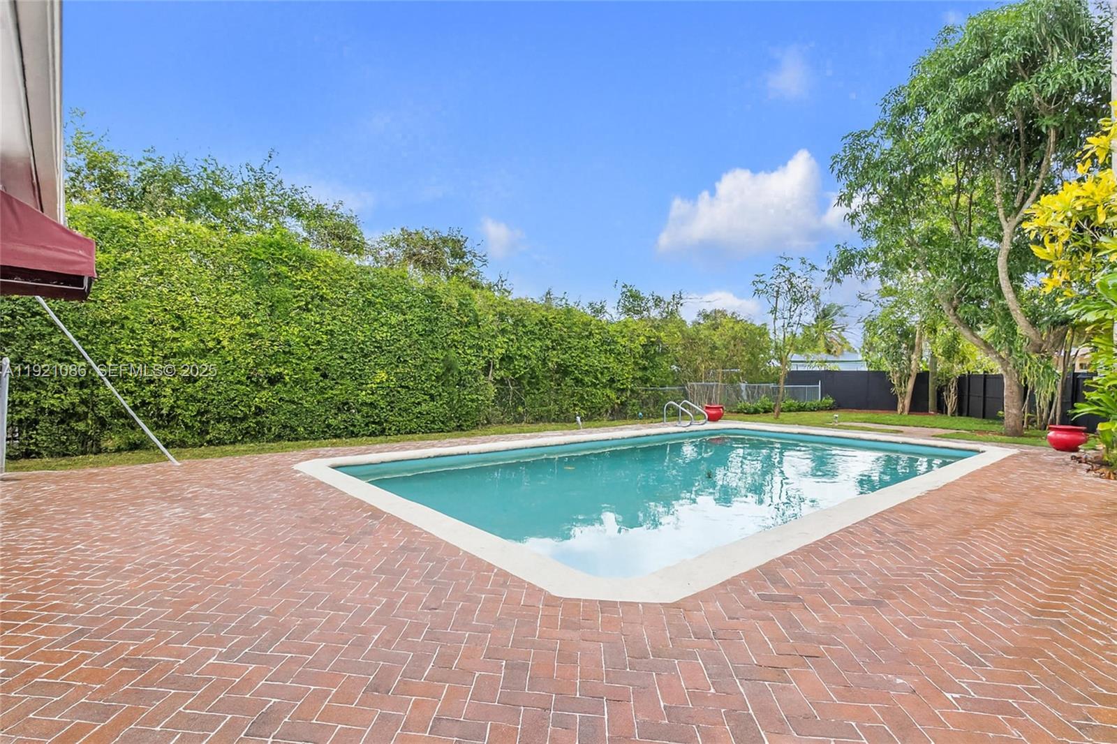 9400 Southwest 193rd Drive, Unit 9400 Cutler Bay, FL 33157 - Photo 35 of 42 a view of a swimming pool with a yard and a fountain