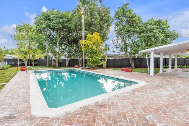 a view of swimming pool with a patio