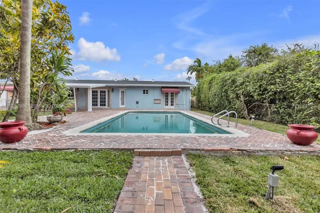 a view of house with backyard space and garden