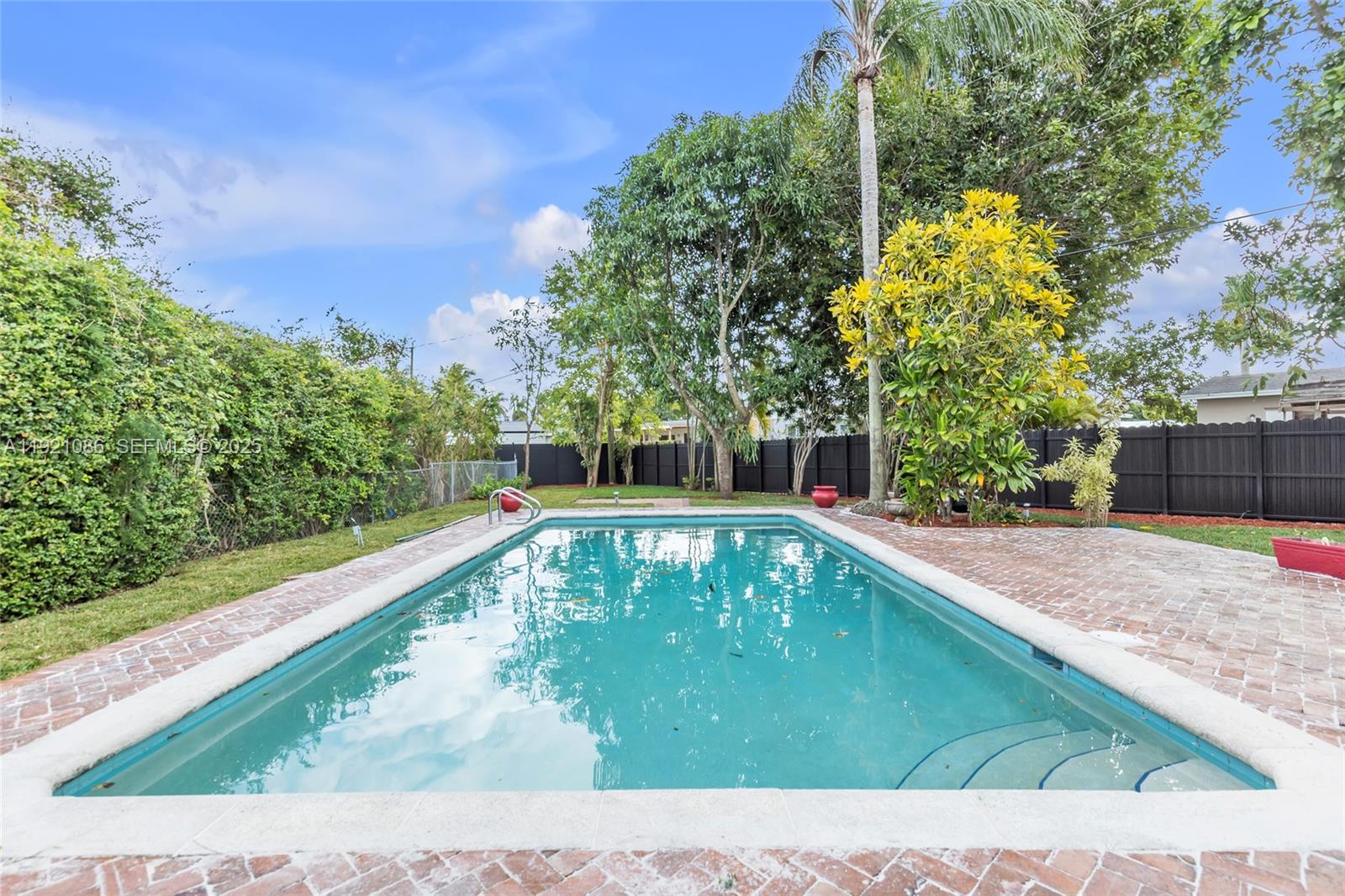 9400 Southwest 193rd Drive, Unit 9400 Cutler Bay, FL 33157 - Photo 39 of 42 a view of a swimming pool with a yard