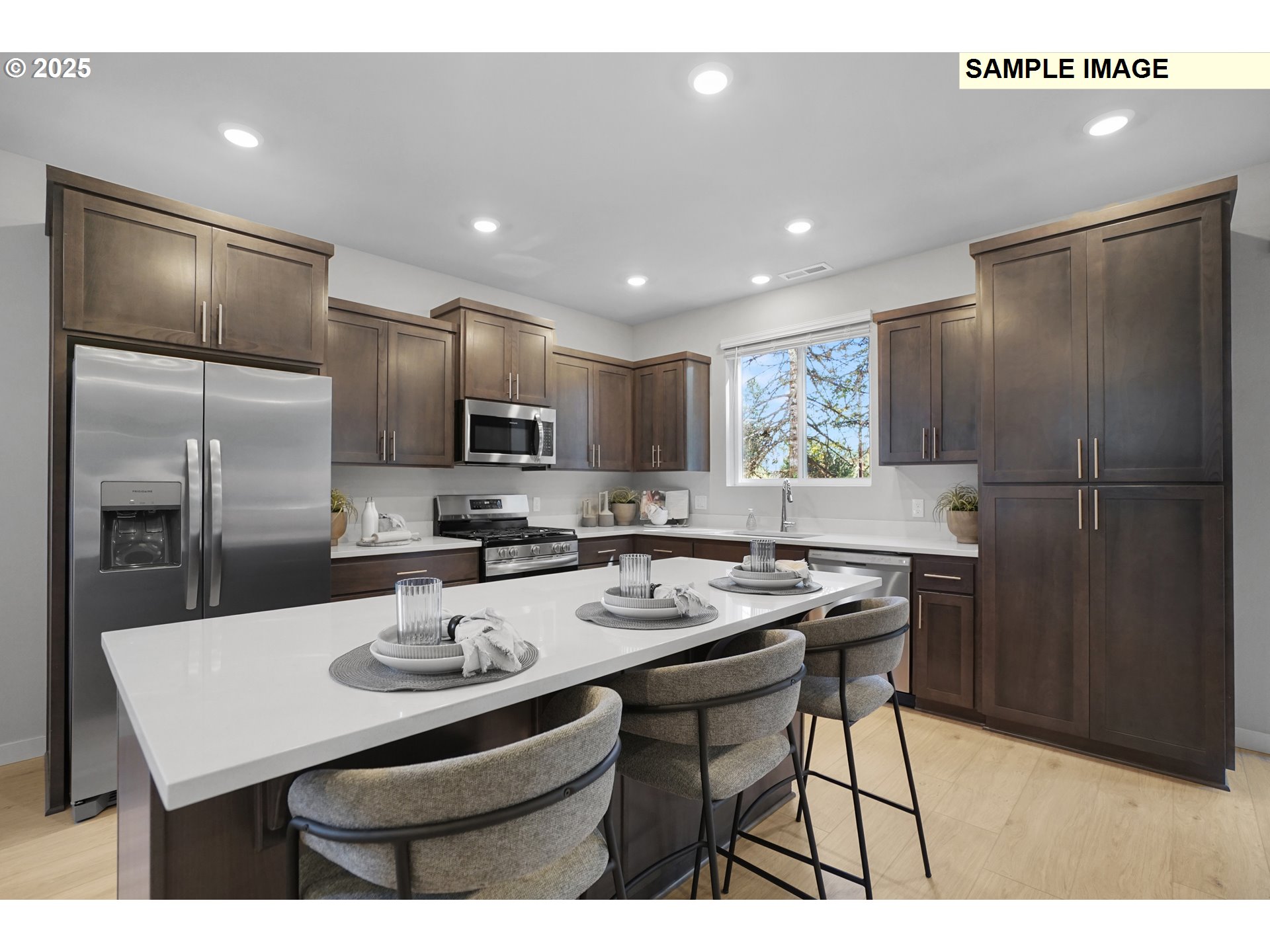 33370 Southwest Rokin Way Scappoose, OR 97056 - Photo 3 of 32 a kitchen with stainless steel appliances kitchen island granite countertop a sink a stove a refrigerator cabinets and chairs