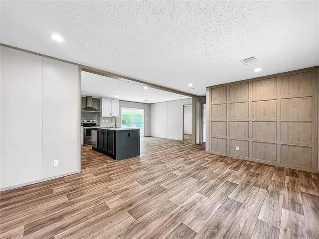 a view of a room with wooden floor