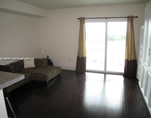 2740 Southwest 28th Terrace, Unit 503 Miami, FL 33133 - Photo 12 of 19 a hallway with a wooden floor and a table