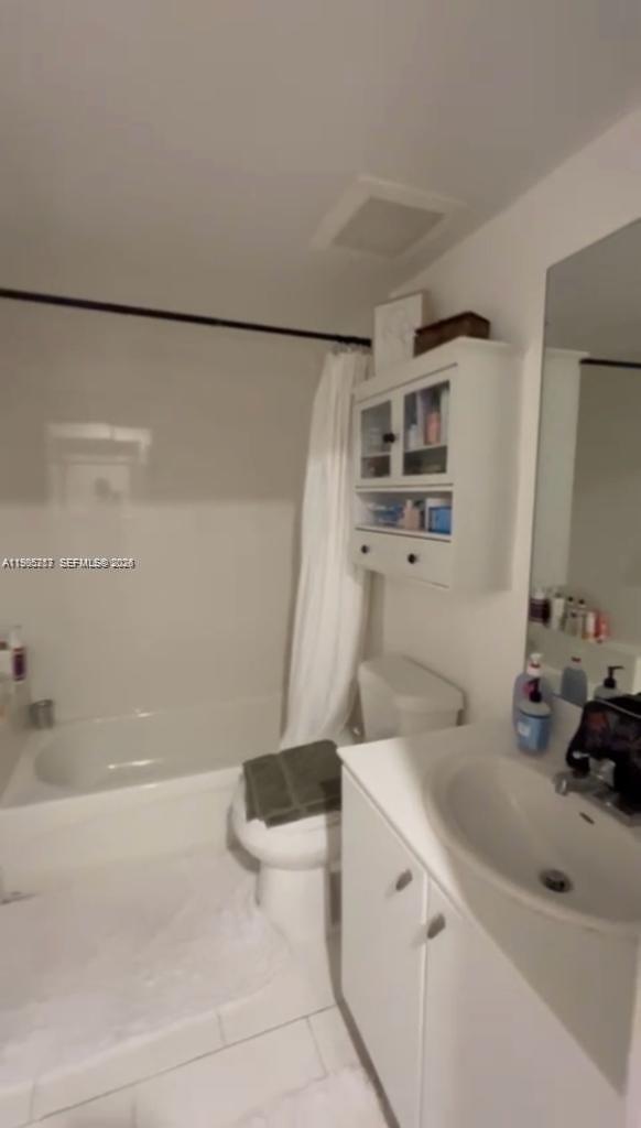 2740 Southwest 28th Terrace, Unit 503 Miami, FL 33133 - Photo 7 of 19 a bathroom with a sink a toilet and shower