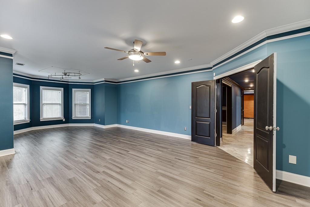 940 Chateau Forest Road Hoschton, GA 30548 - Photo 68 of 87 a view of empty room with wooden floor and fan