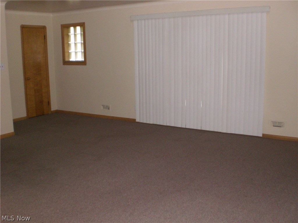 8401-03 Pelham Drive Parma, OH 44129 - Photo 11 of 18 LARGE LIVING ROOM WITH A CLOSET AND DOOR AROUND THE CORNER - ACROSS FROM THE GLASS BLOCK WINDOW