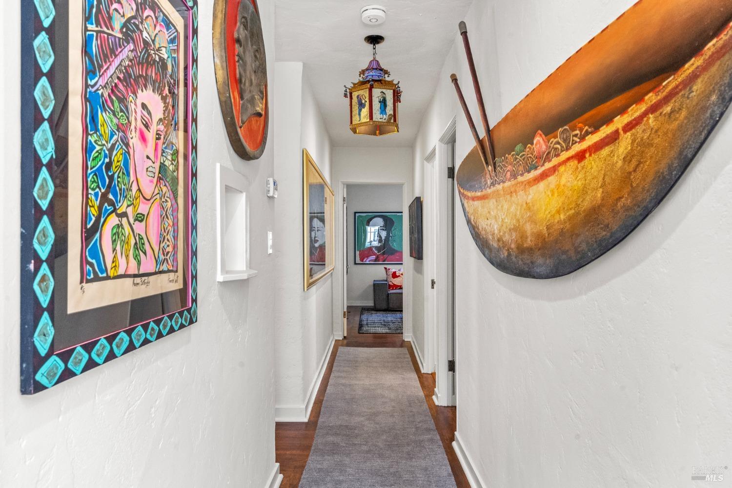 93 Cascade Drive Fairfax, CA 94930 - Photo 26 of 61 a hallway with painting on the wall and a potted plant