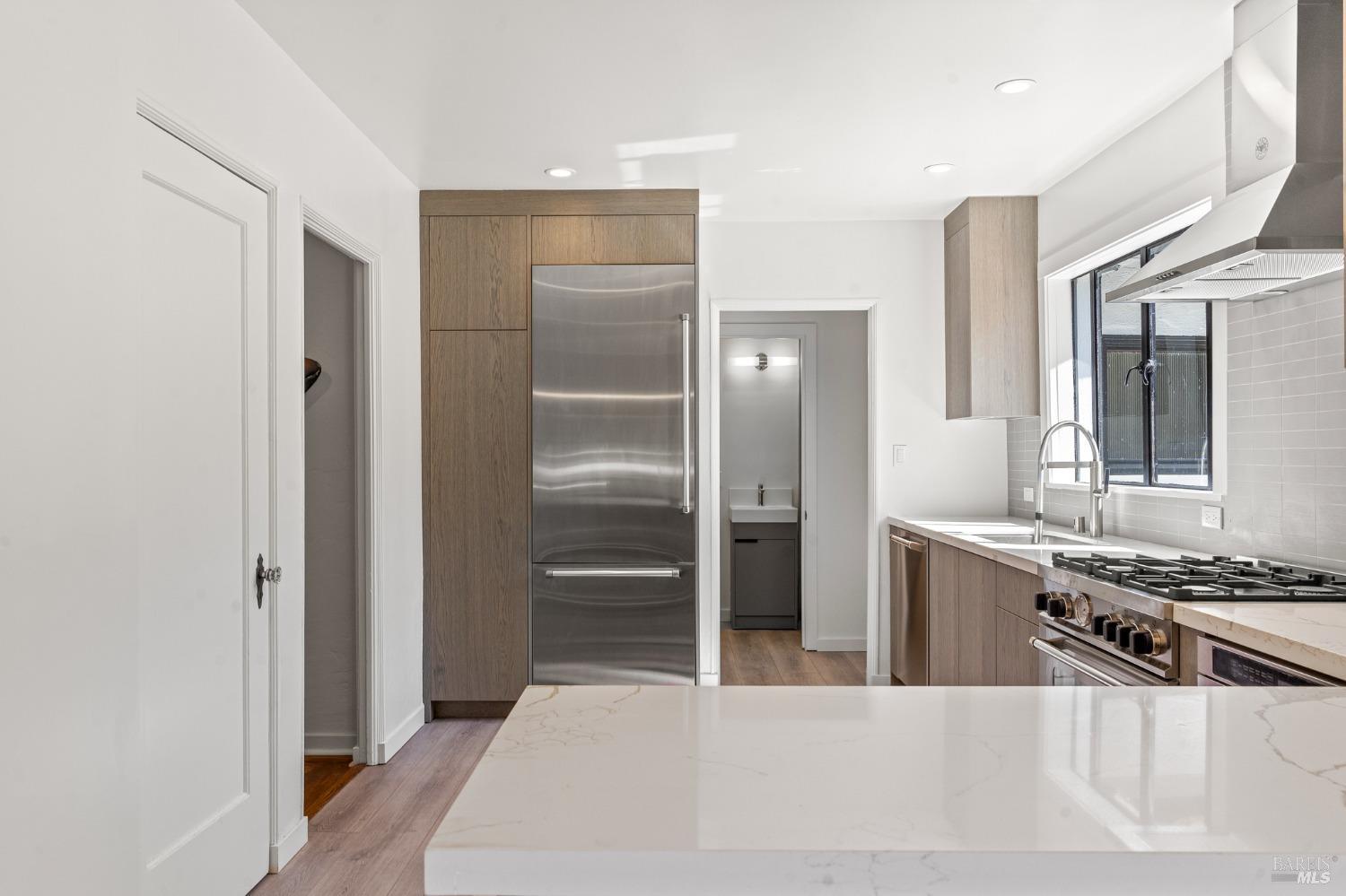 93 Cascade Drive Fairfax, CA 94930 - Photo 28 of 61 a kitchen with stainless steel appliances kitchen island a refrigerator sink and stove