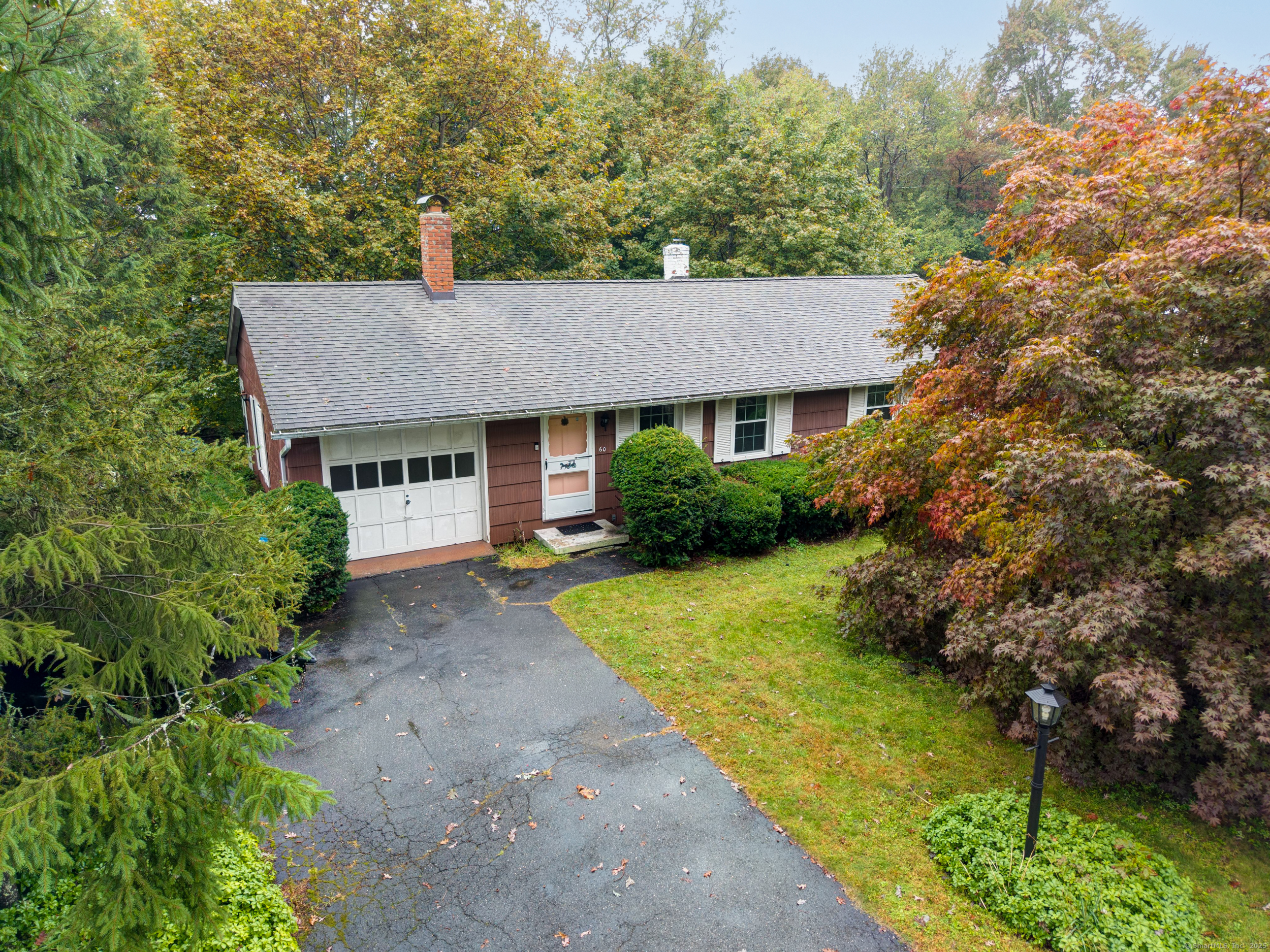 a aerial view of a house with yard and green space